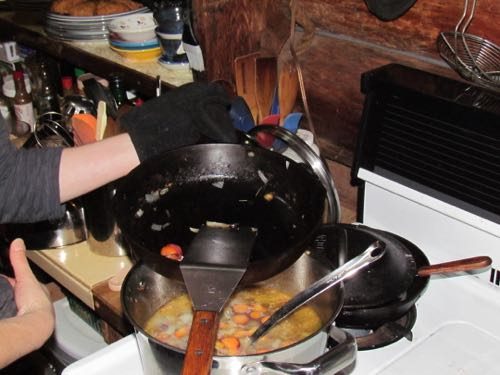 Michelle demonstrates the "Julia grip" while braising vegetables for breakfast (Photo: Mark A. Zeiger).